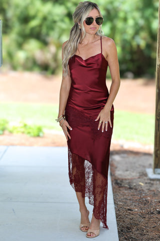 Woman wearing a burgundy lace satin dress 