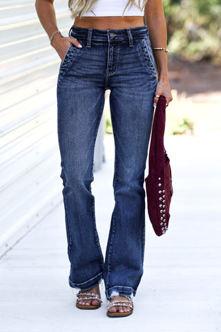 Person wearing blue jeans with a blurred background