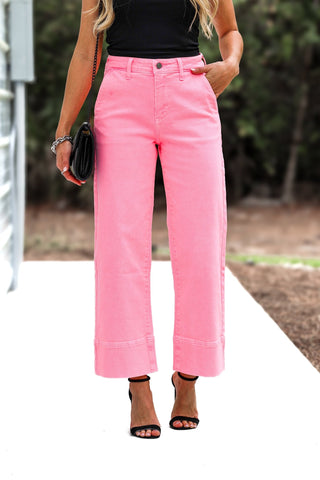 Person wearing bright pink pants with a blurred background